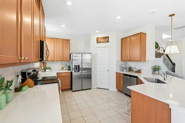a kitchen with cabinets and stainless steel appliances