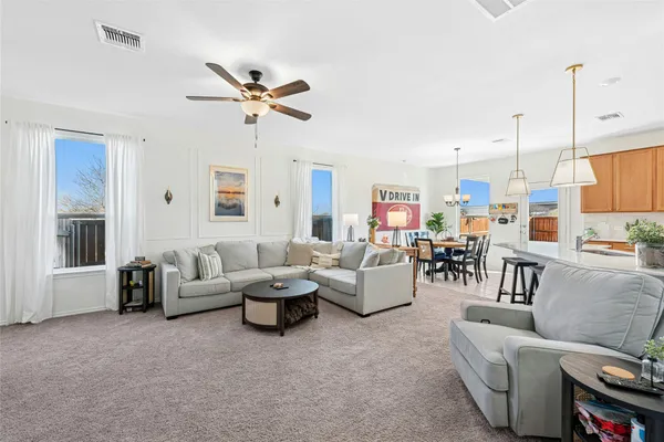 a living room with furniture ceiling fan and a rug