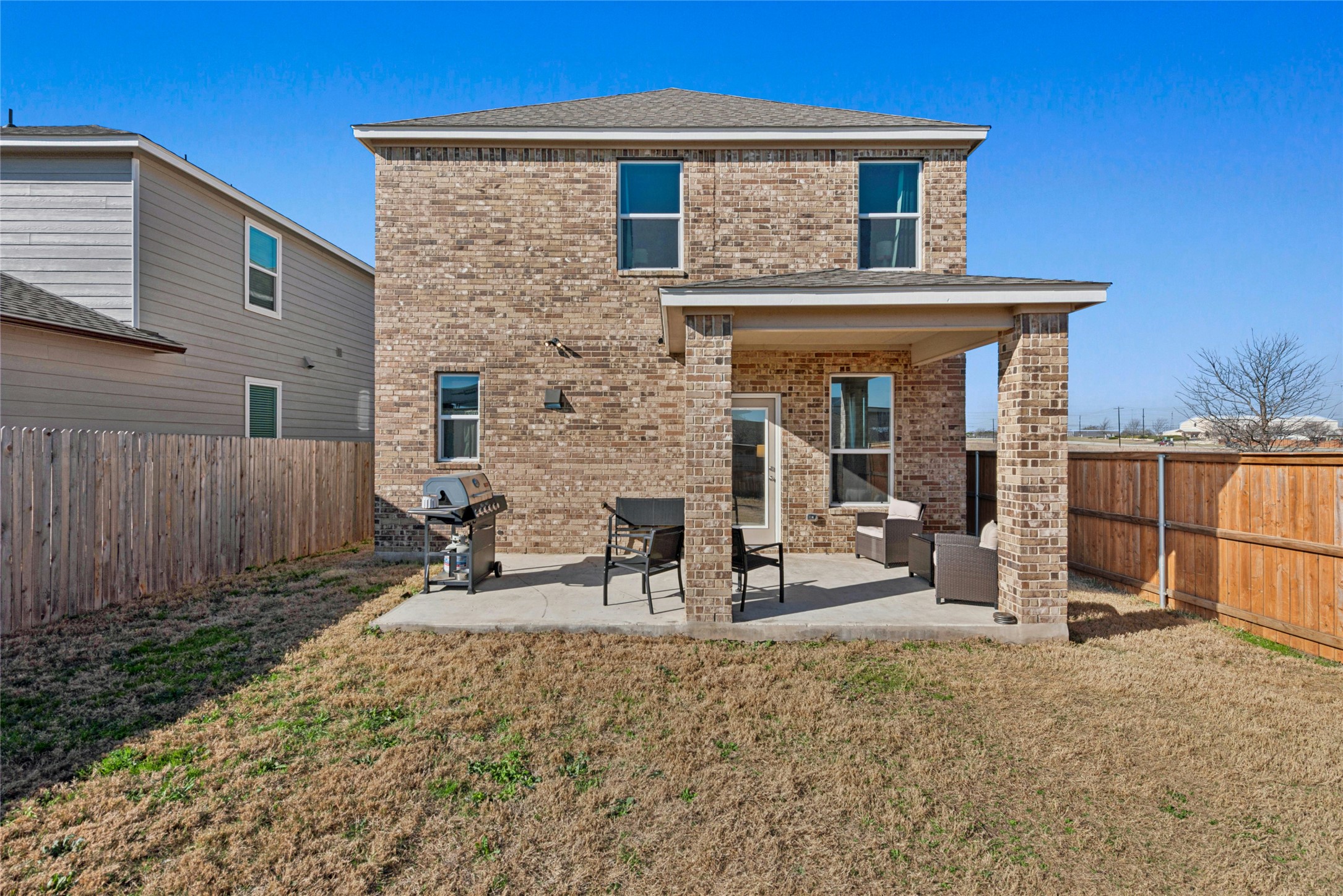 2001 Saskatoon Street Georgetown, TX 78626 - Photo 2 of 40 The brick façade adds timeless elegance and enhances the home’s refined curb appeal. Enjoy outdoor living on the charming patio with an extended covered porch that offers added privacy and overlooks the fully fenced backyard. The extended porch also includes a dedicated grilling area—perfect for relaxing or entertaining.