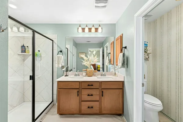 a bathroom with a sink vanity mirror and toilet