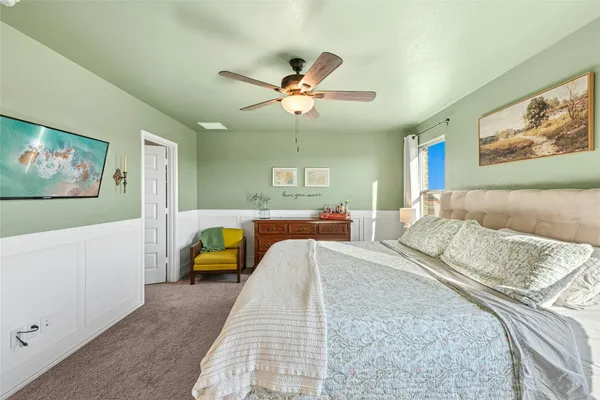 a bedroom with a bed couch and a window