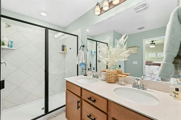 a bathroom with a double vanity sink mirror and double