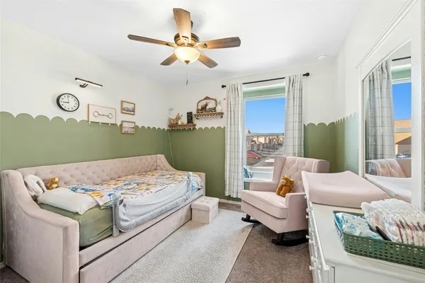 a bedroom with a bed wooden floor and window