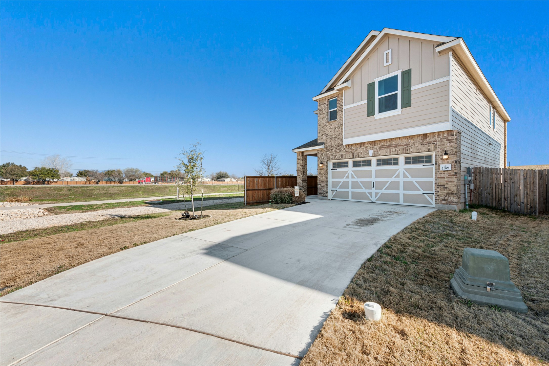 2001 Saskatoon Street Georgetown, TX 78626 - Photo 4 of 40 View of front of property with an attached garage, driveway, board and batten siding, and brick siding