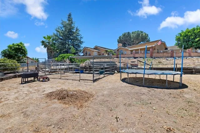 an aerial view of residential houses with outdoor space and trees