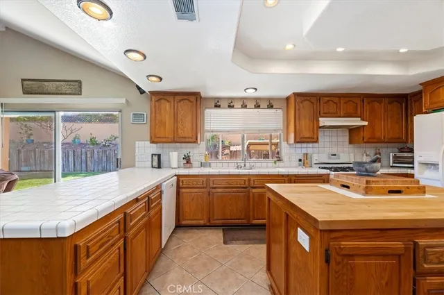 a bedroom with a bed and dresser with mirror