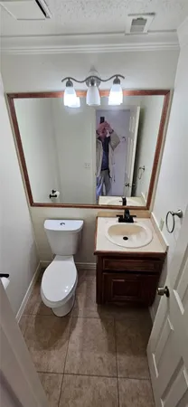 a bathroom with a sink toilet and mirror