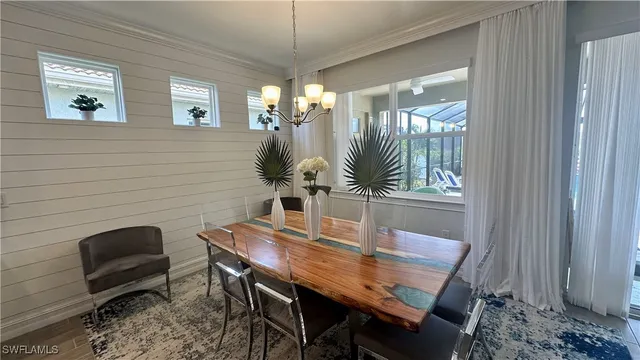 a living room with furniture a rug kitchen view and a large window
