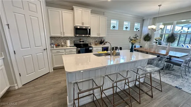 a kitchen with stainless steel appliances a stove refrigerator sink and cabinets