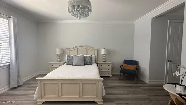 a large bed sitting in a bedroom next to a window