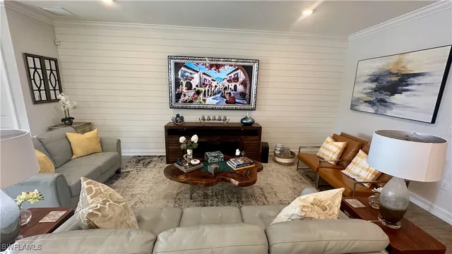 a living room with furniture a couch and a lamp