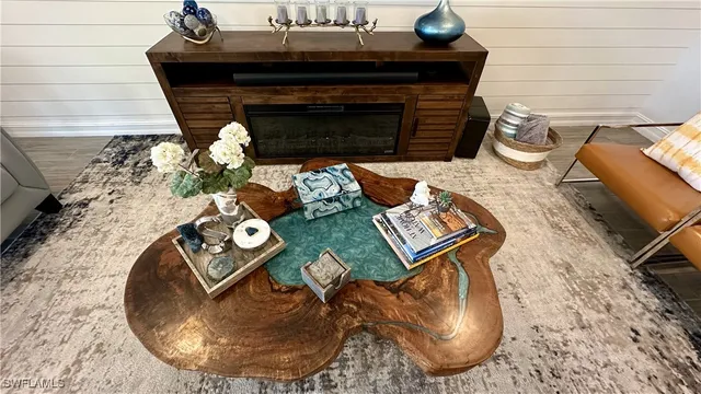 a view of a living room area with furniture and a potted plant