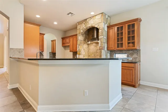 a kitchen with stainless steel appliances granite countertop a sink and a refrigerator