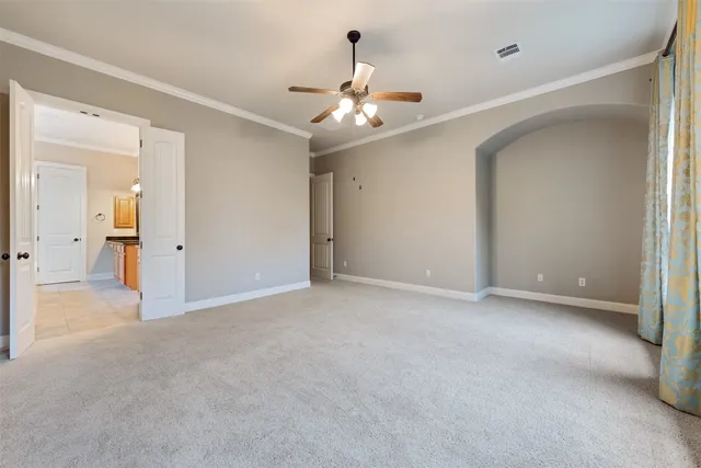 a view of an empty room with a ceiling fan