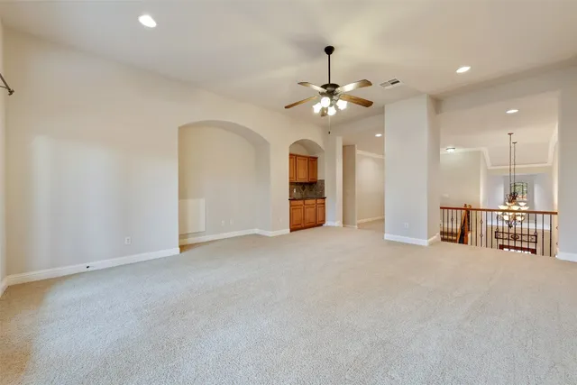 a view of an empty room with a kitchen