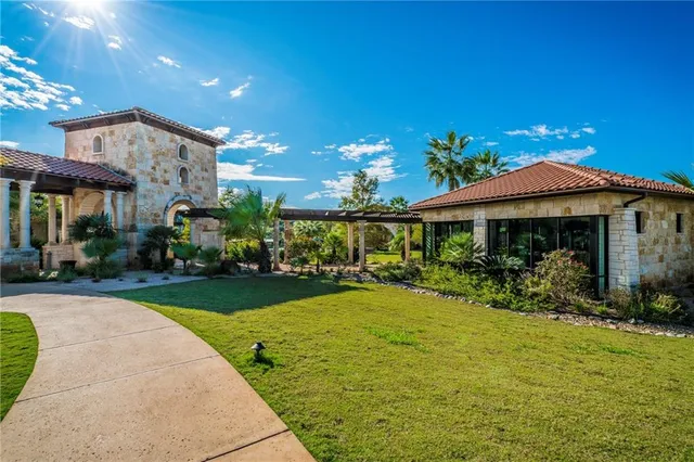 a view of a house with swimming pool and sitting area