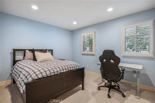 a bedroom with a bed and a desk
