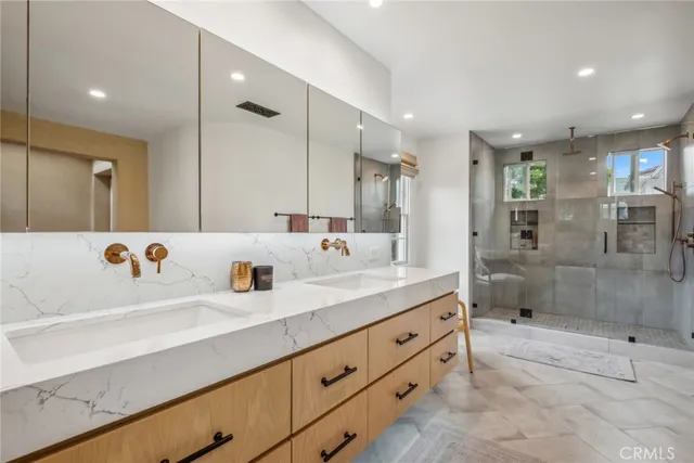 a bathroom with a double vanity sink mirror double and shower