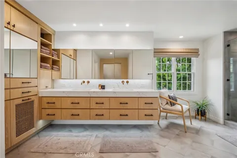 a bathroom with a sink double vanity and a large mirror