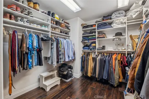 a view of walk in closet with clothes and shoes