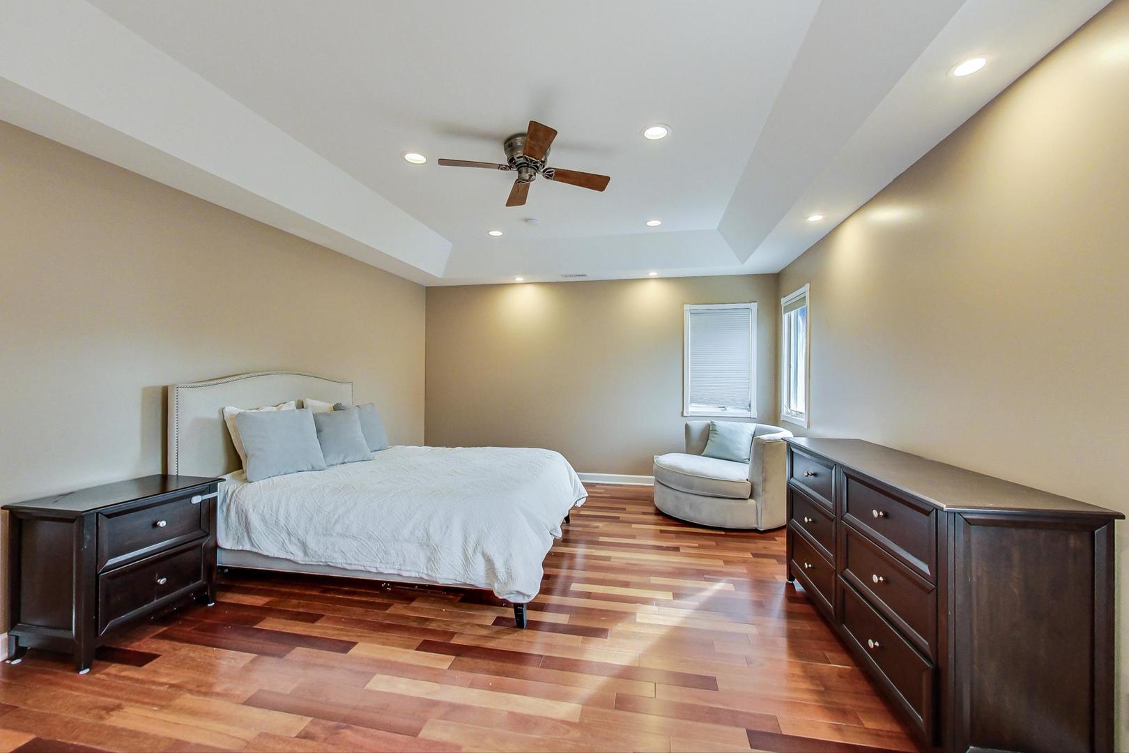 482 Sumac Road Highland Park, IL 60035 - Photo 13 of 29 a bedroom with a bed and wooden floor