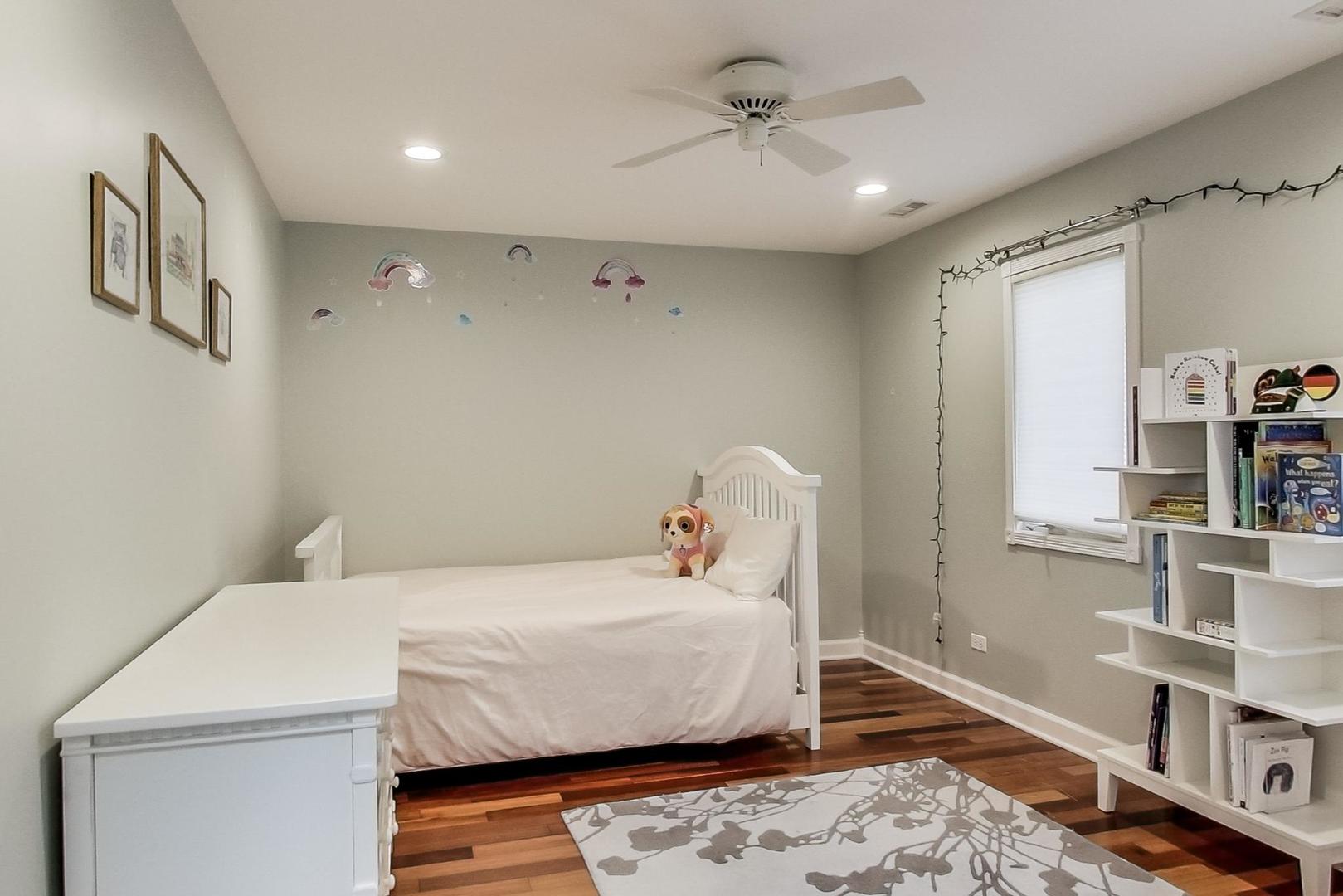 482 Sumac Road Highland Park, IL 60035 - Photo 16 of 29 a bedroom with a bed and wooden floor