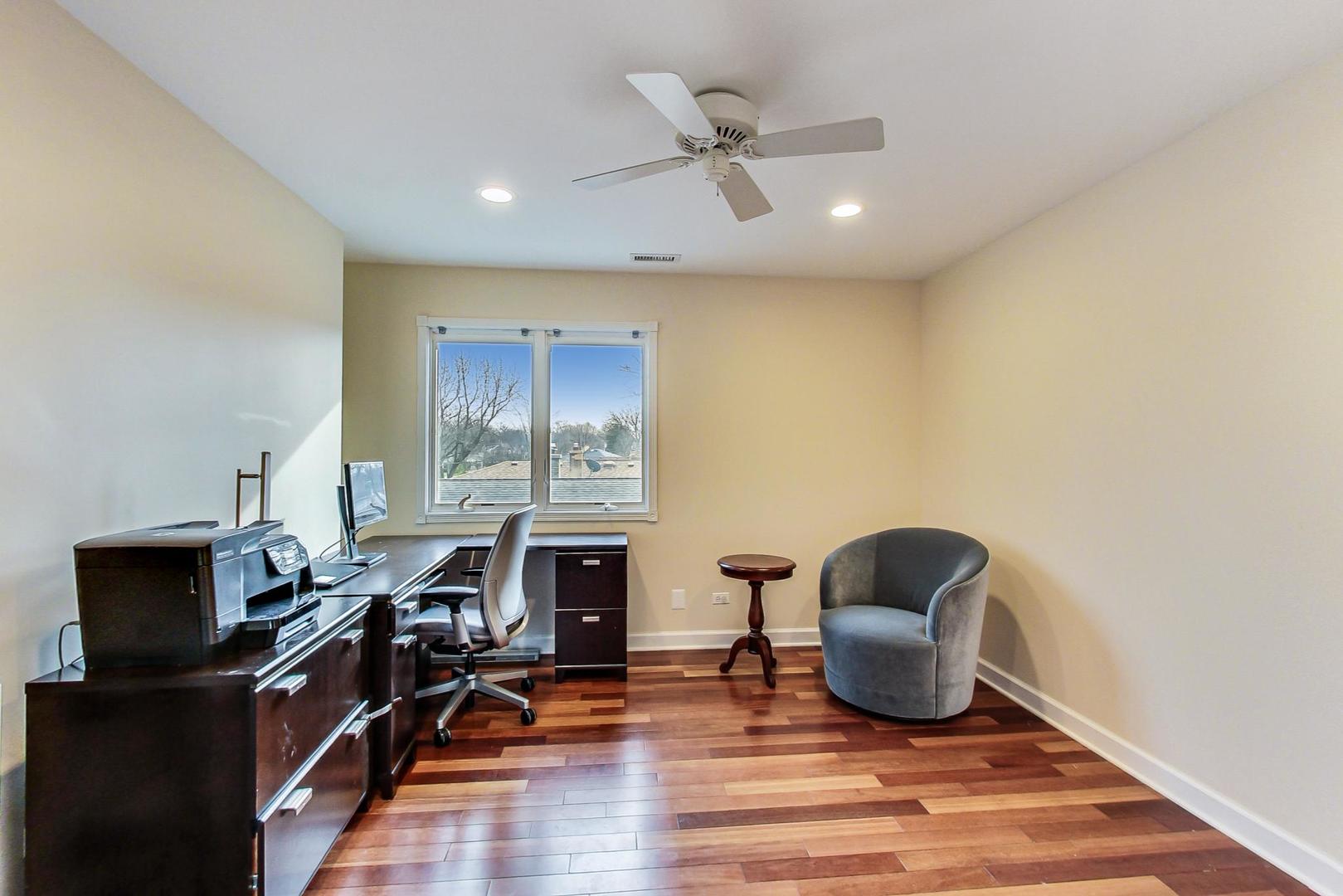 482 Sumac Road Highland Park, IL 60035 - Photo 18 of 29 a living room with furniture a fireplace and a flat screen tv