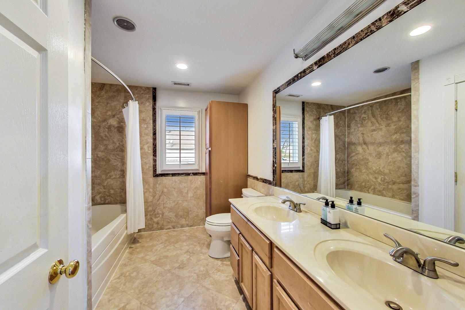 482 Sumac Road Highland Park, IL 60035 - Photo 19 of 29 a bathroom with double vanity sinks and a mirror