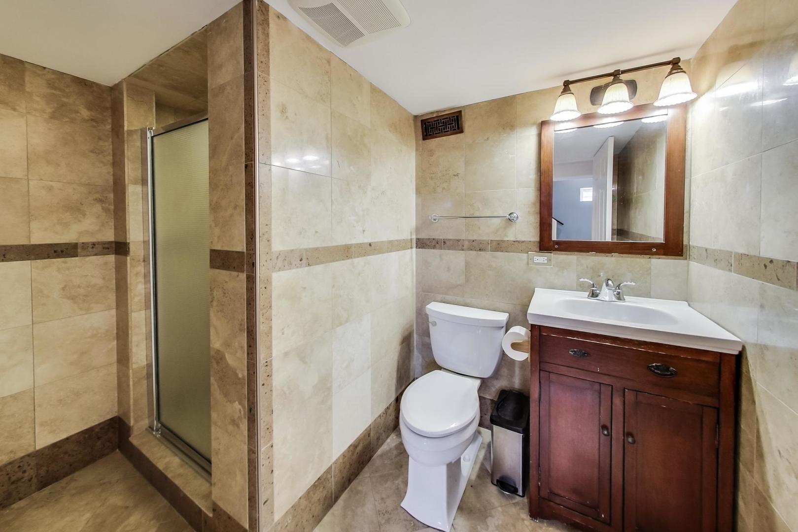 482 Sumac Road Highland Park, IL 60035 - Photo 20 of 29 a bathroom with a granite countertop sink toilet and shower
