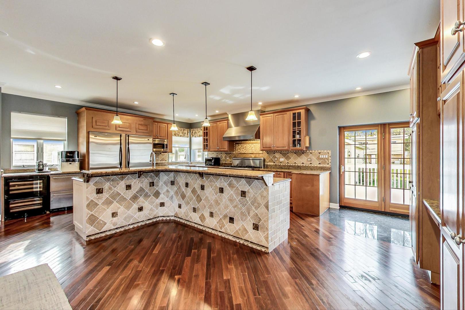 482 Sumac Road Highland Park, IL 60035 - Photo 10 of 29 a kitchen with stainless steel appliances granite countertop a stove a sink dishwasher a refrigerator and white cabinets with wooden floor