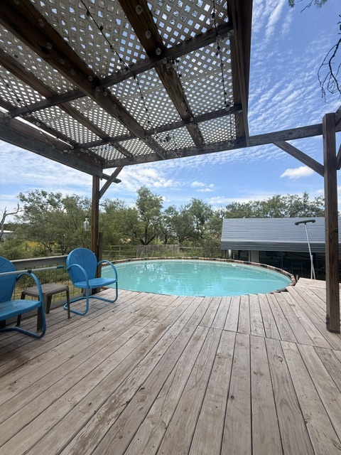 221 Winding Way Road Marble Falls, TX 78654 - Photo 16 of 19 A spacious wooden deck surrounds a refreshing above-ground pool, perfect for outdoor leisure and summer days!