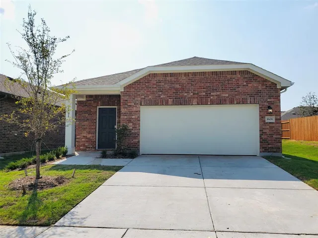 a front view of a house with yard