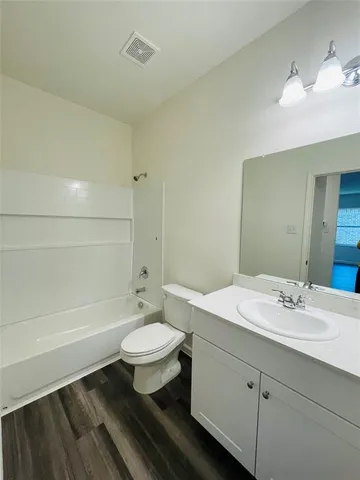 a bathroom with a sink toilet a mirror and shower