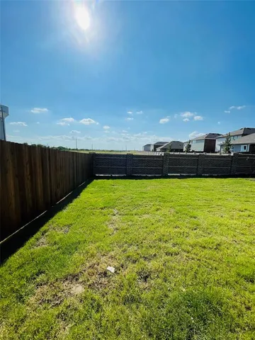 a view of a swimming pool and a yard