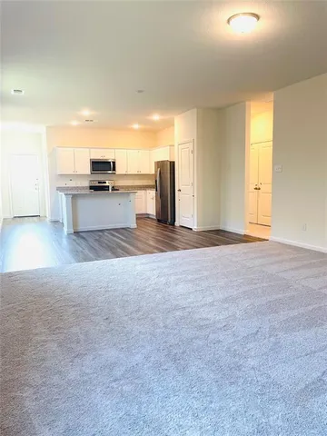 a view of a livingroom with a kitchen