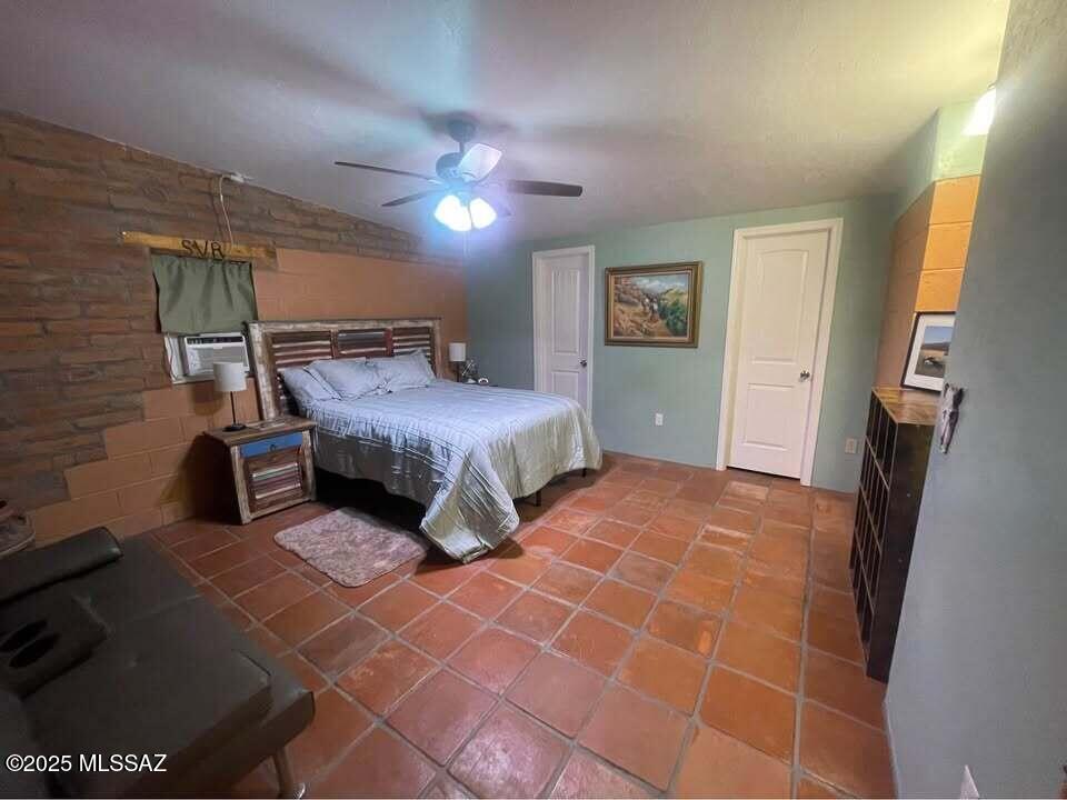 1094 North Pomerene Road Benson, AZ 85602 - Photo 10 of 48 a bedroom with a bed and a mirror