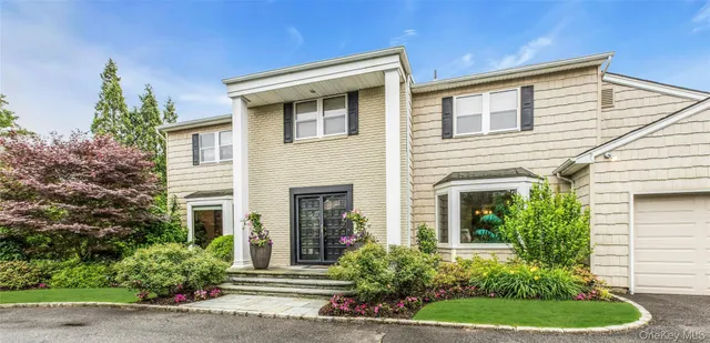 a front view of a house with a yard