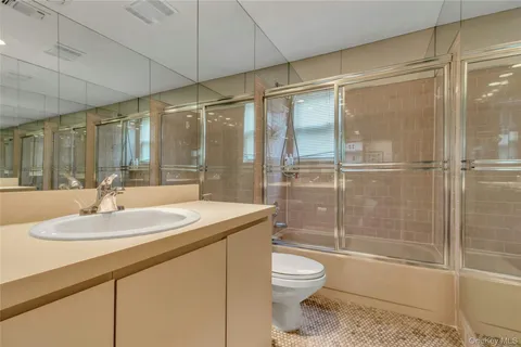 a spacious bedroom with a bed and a window