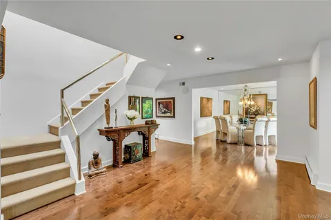 a view of entryway livingroom and hall with wooden floor