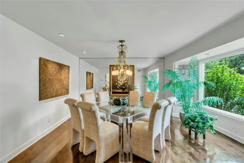a dining room with furniture window and wooden floor