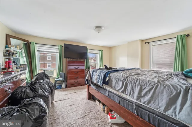 a bedroom with a bed and flat screen tv
