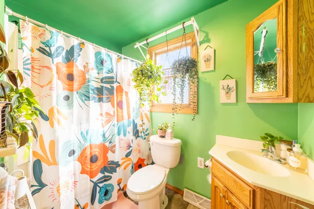 a bathroom with a sink a toilet and a mirror