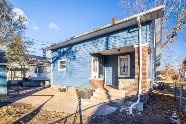 a view of a patio with table and chairs with wooden fence