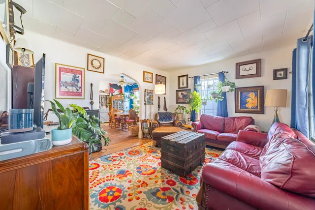 a living room with fireplace furniture and a flat screen tv