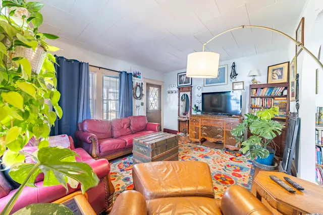 a living room with furniture fireplace and a chandelier
