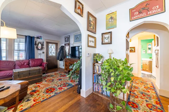 a living room with furniture and a potted plant