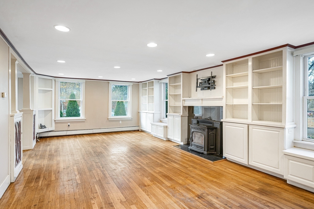 167 North Road Chelmsford, MA 01824 - Photo 8 of 38 a view of empty room with wooden floor and fireplace