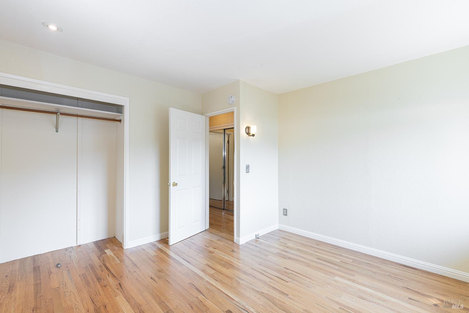 18090 Las Lomas Road Sonoma, CA 95476 - Photo 27 of 37 a view of an empty room with wooden floor and a window