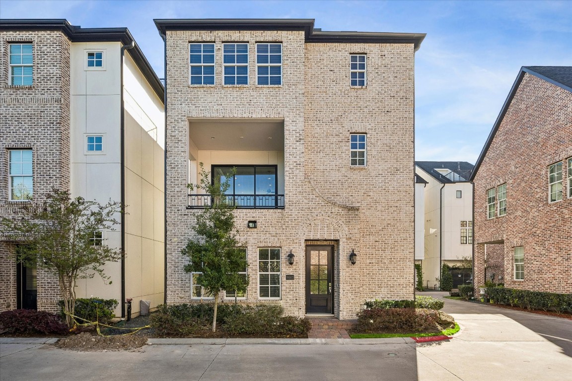 a front view of a building with a yard