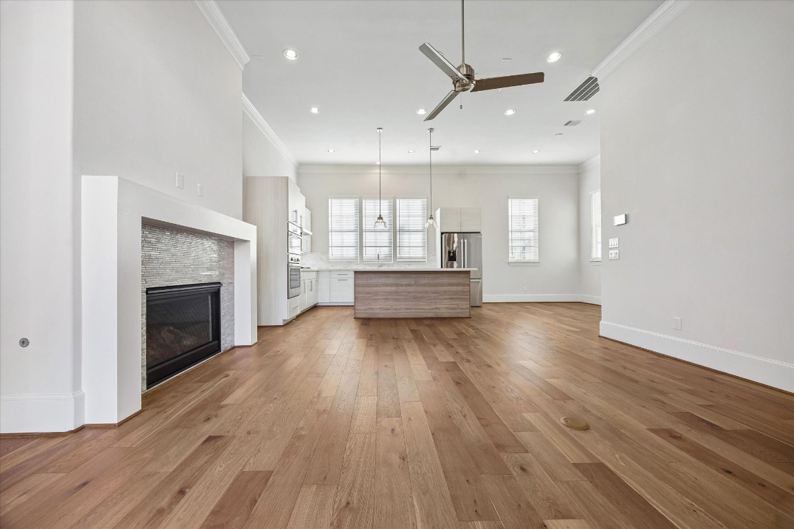 9663 Kings Cross Station Houston, TX 77045 - Photo 11 of 30 an empty room with wooden floor fireplace and windows